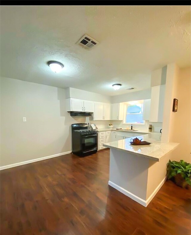 717 Grantham Rd, Baytown, TX 77521 - kitchen with black gas range oven, a peninsula, under cabinet range hood, white cabinetry, and light countertops