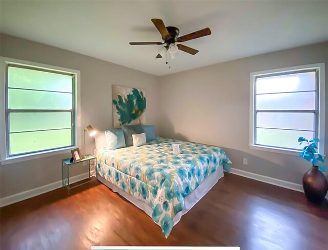 717 Grantham Rd, Baytown, TX 77521 - bedroom with multiple windows, wood finished floors, and baseboards