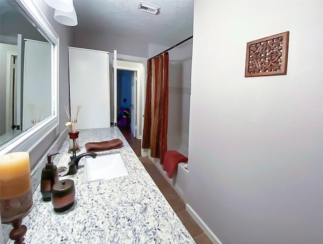 717 Grantham Rd, Baytown, TX 77521 - bathroom with a sink and a textured ceiling