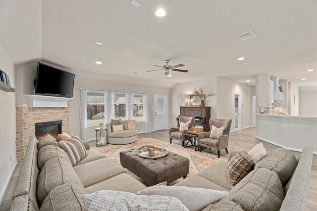 2221 Hay Field Ct, Conroe, TX 77384 - living room featuring a fireplace, light wood-style floors, recessed lighting, ceiling fan, and baseboards