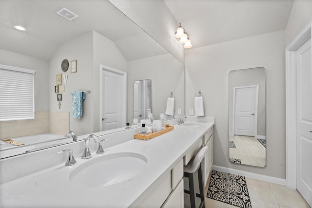 2221 Hay Field Ct, Conroe, TX 77384 - full bathroom featuring double vanity, tile patterned flooring, baseboards, and vaulted ceiling