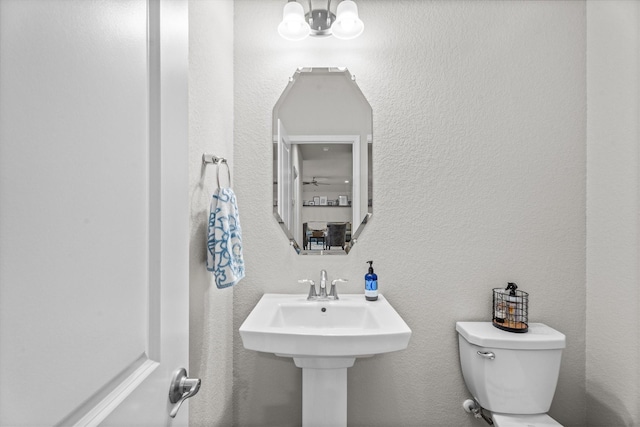 2221 Hay Field Ct, Conroe, TX 77384 - half bathroom with toilet and a textured wall