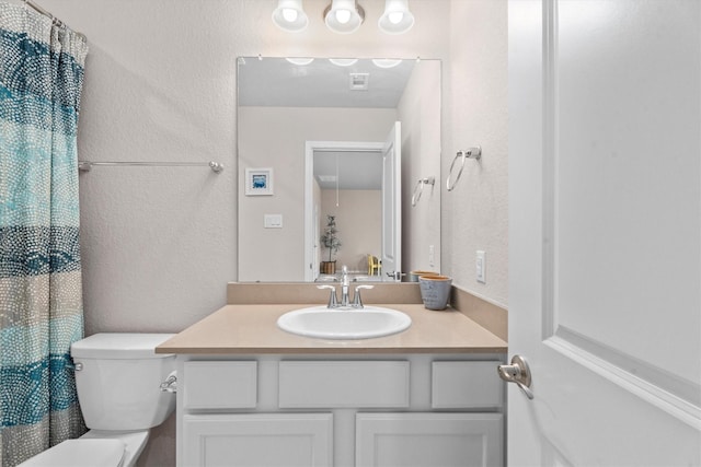 2221 Hay Field Ct, Conroe, TX 77384 - bathroom featuring vanity, toilet, a textured wall, and a shower with shower curtain