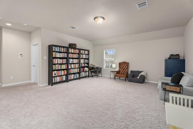 2221 Hay Field Ct, Conroe, TX 77384 - living area featuring baseboards, light carpet, and a textured ceiling