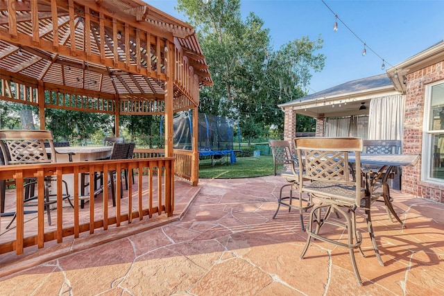 8807 Stones Throw Ln, Missouri City, TX 77459 - view of patio / terrace with a trampoline and outdoor dining area