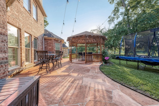 8807 Stones Throw Ln, Missouri City, TX 77459 - view of patio / terrace featuring outdoor dining space, a trampoline, and a gazebo