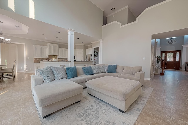 8807 Stones Throw Ln, Missouri City, TX 77459 - living area with a chandelier, a towering ceiling, baseboards, light tile patterned flooring, and ornate columns
