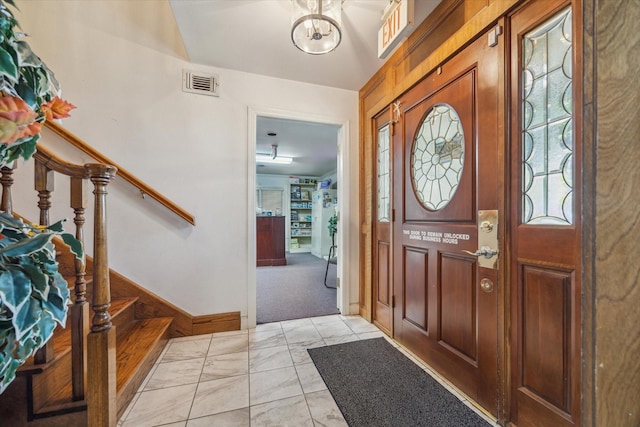 5135 Edloe St, Houston, TX 77005 - entryway featuring stairway, light marble finish floors, a chandelier, and baseboards