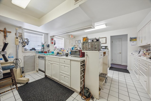 5135 Edloe St, Houston, TX 77005 - kitchen featuring light tile patterned floors, light countertops, white cabinetry, and dishwashing machine