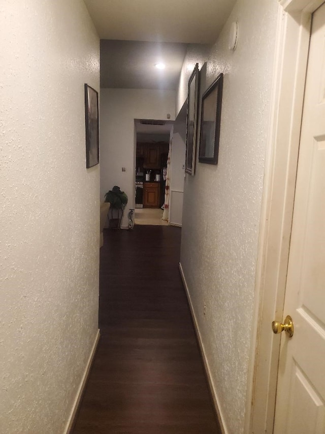 12110 Hillcrest Dr, Pinehurst, TX 77362 - hallway with a textured wall, dark wood finished floors, and baseboards