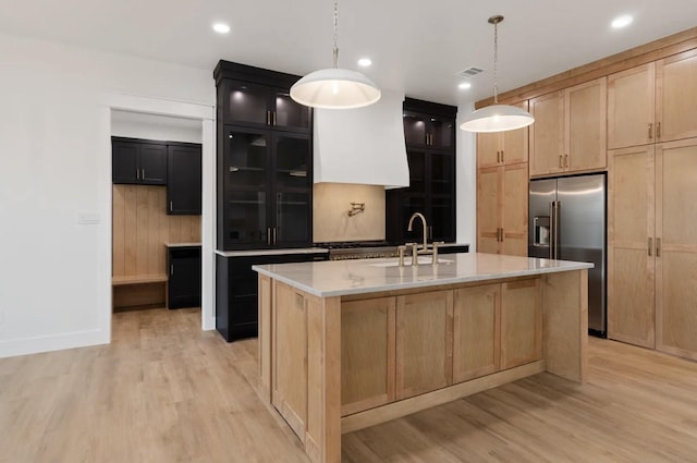 16685 Kelton, Iola, TX 77861 - kitchen featuring high end fridge, a sink, light wood-type flooring, light brown cabinetry, and recessed lighting