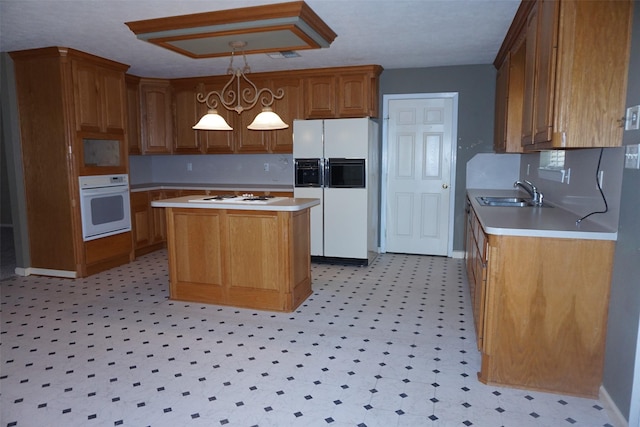 19710 Lowe St, Porter, TX 77365 - kitchen with white appliances, a sink, light countertops, a center island, and light flooring
