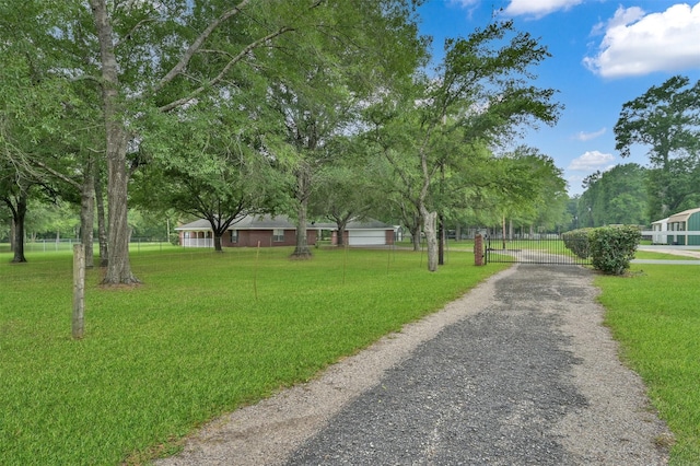 19710 Lowe St, Porter, TX 77365 - view of community with a gate and driveway