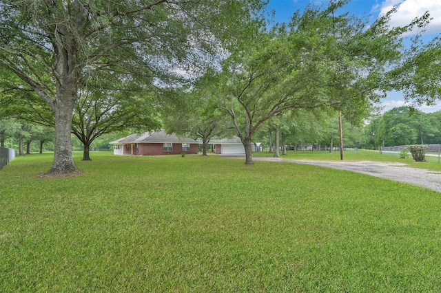 19710 Lowe St, Porter, TX 77365 - view of yard with driveway and a garage