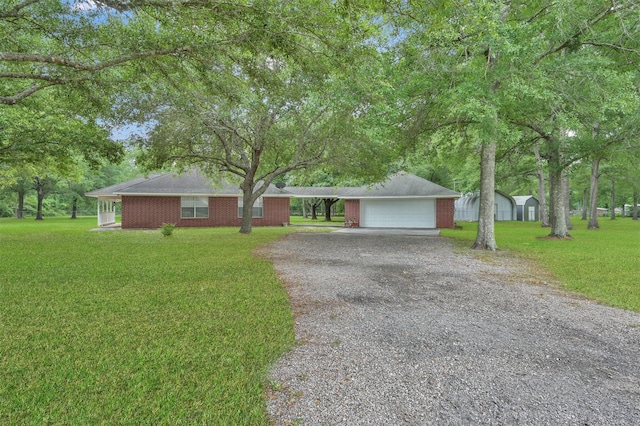 19710 Lowe St, Porter, TX 77365 - ranch-style house featuring gravel driveway, an outdoor structure, a front lawn, and a garage