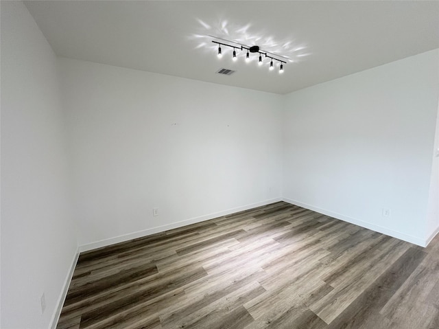 3231 Langley Bend Ln, Fulshear, TX 77441 - empty room featuring wood finished floors, track lighting, and baseboards