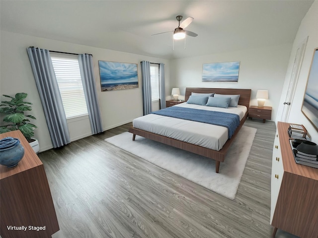 3231 Langley Bend Ln, Fulshear, TX 77441 - bedroom with wood finished floors, baseboards, and ceiling fan