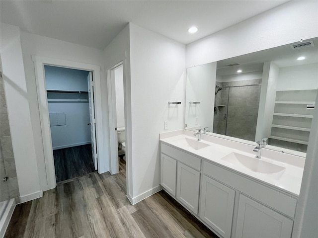 3231 Langley Bend Ln, Fulshear, TX 77441 - full bath featuring a stall shower, wood finished floors, a spacious closet, toilet, and double vanity