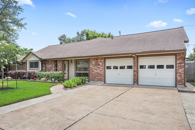1109 Alan St, Deer Park, TX 77536 - view of front of home with concrete driveway, brick siding, an attached garage, and a shingled roof