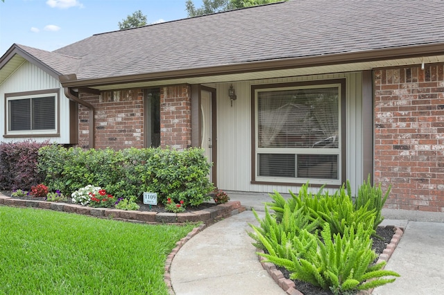 1109 Alan St, Deer Park, TX 77536 - property entrance featuring roof with shingles, brick siding, and covered porch