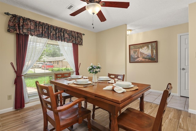 1109 Alan St, Deer Park, TX 77536 - dining room featuring a ceiling fan, baseboards, light wood-style flooring, and a textured ceiling