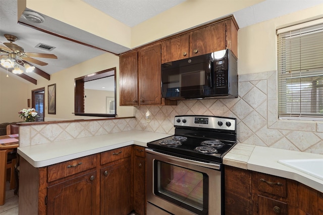 1109 Alan St, Deer Park, TX 77536 - kitchen featuring black microwave, electric range, light countertops, ceiling fan, and backsplash