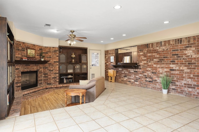 1109 Alan St, Deer Park, TX 77536 - living room featuring a fireplace, brick wall, a ceiling fan, recessed lighting, and wood finished floors