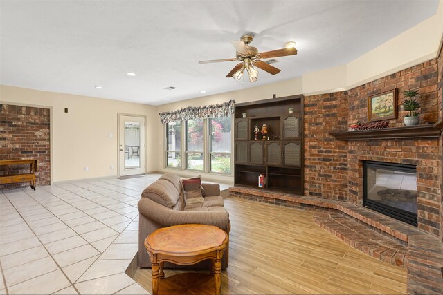 1109 Alan St, Deer Park, TX 77536 - living room featuring a brick fireplace, ceiling fan, and wood finished floors