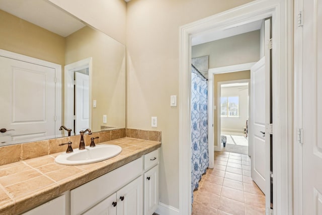 24807 Thorton Knolls Dr, Spring, TX 77389 - full bath featuring vanity, tile patterned flooring, baseboards, and a shower with shower curtain