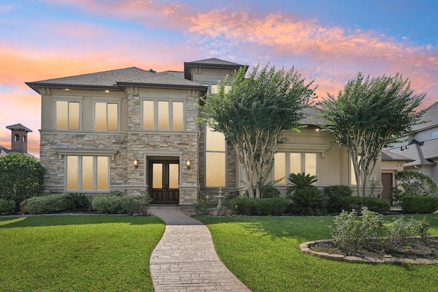 24807 Thorton Knolls Dr, Spring, TX 77389 - view of front of home with french doors, stone siding, a front lawn, and stucco siding