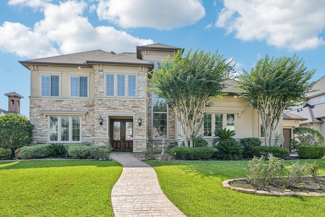 24807 Thorton Knolls Dr, Spring, TX 77389 - view of front of house featuring french doors, stucco siding, a front lawn, and stone siding