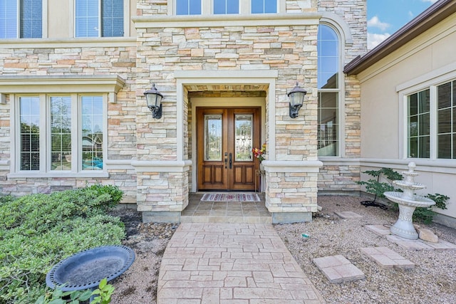 24807 Thorton Knolls Dr, Spring, TX 77389 - entrance to property featuring stone siding and french doors