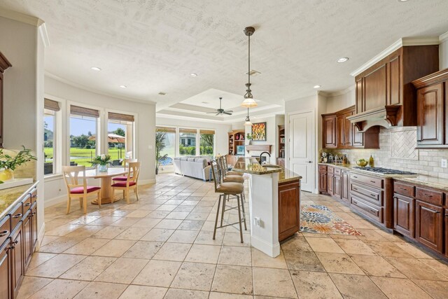 24807 Thorton Knolls Dr, Spring, TX 77389 - kitchen with decorative backsplash, recessed lighting, a kitchen bar, stainless steel gas stovetop, and baseboards