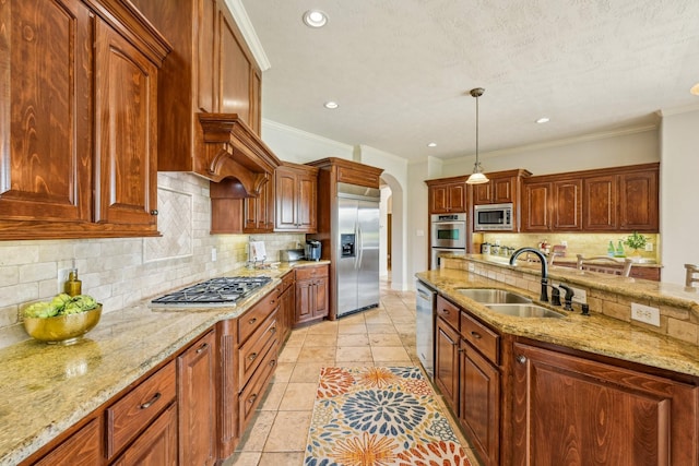 24807 Thorton Knolls Dr, Spring, TX 77389 - kitchen with built in appliances, a sink, arched walkways, decorative backsplash, and decorative light fixtures