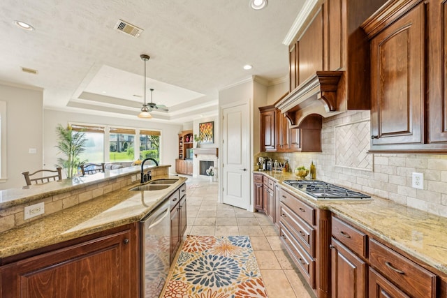 24807 Thorton Knolls Dr, Spring, TX 77389 - kitchen with a sink, appliances with stainless steel finishes, tasteful backsplash, light stone counters, and recessed lighting