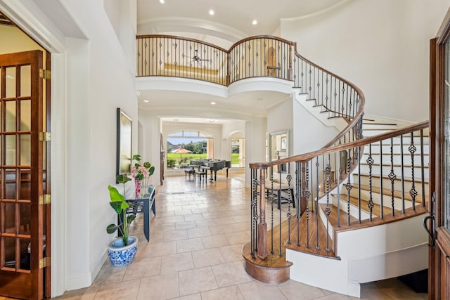 24807 Thorton Knolls Dr, Spring, TX 77389 - entrance foyer with a towering ceiling, arched walkways, stairway, baseboards, and recessed lighting