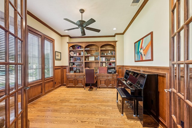24807 Thorton Knolls Dr, Spring, TX 77389 - office area with wainscoting, ornamental molding, a ceiling fan, light wood-style flooring, and built in study area