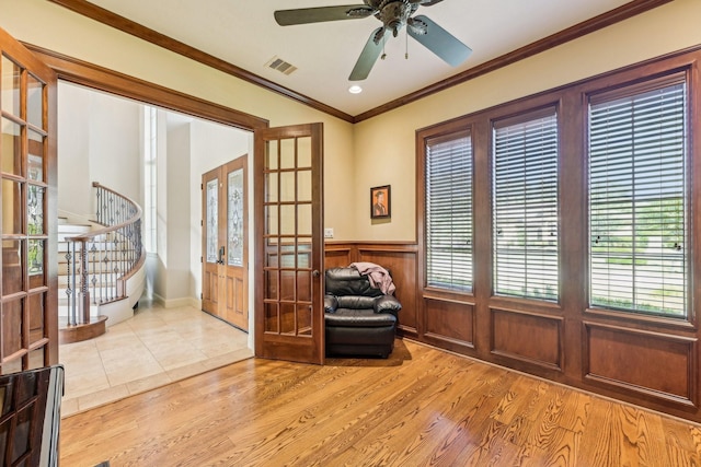 24807 Thorton Knolls Dr, Spring, TX 77389 - living area with french doors, stairway, wood finished floors, wainscoting, and crown molding