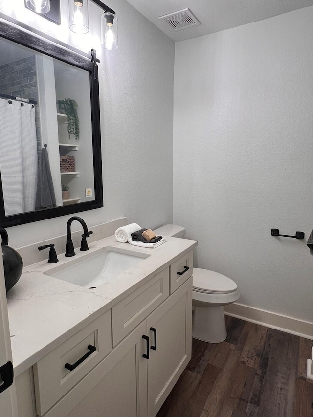1618 Del Norte St, Houston, TX 77018 - full bath with wood finished floors, vanity, toilet, baseboards, and curtained shower