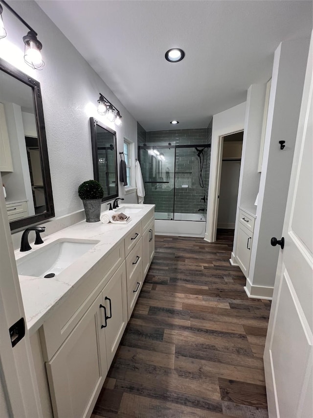 1618 Del Norte St, Houston, TX 77018 - full bathroom featuring a shower with shower door, wood finished floors, double vanity, and recessed lighting