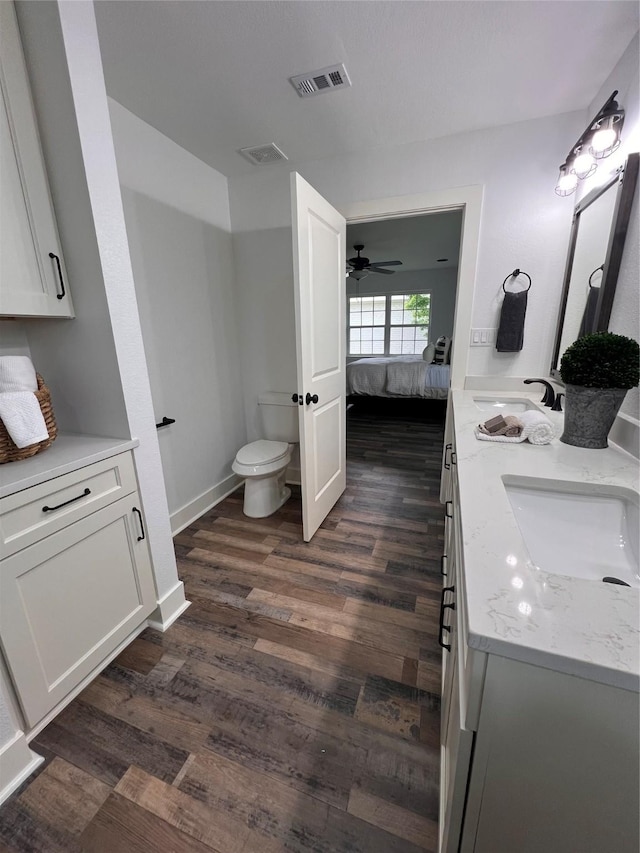 1618 Del Norte St, Houston, TX 77018 - bathroom featuring connected bathroom, wood finished floors, toilet, and ceiling fan