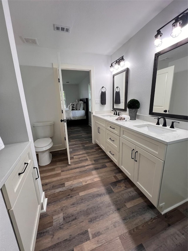 1618 Del Norte St, Houston, TX 77018 - ensuite bathroom with wood finished floors, double vanity, and toilet
