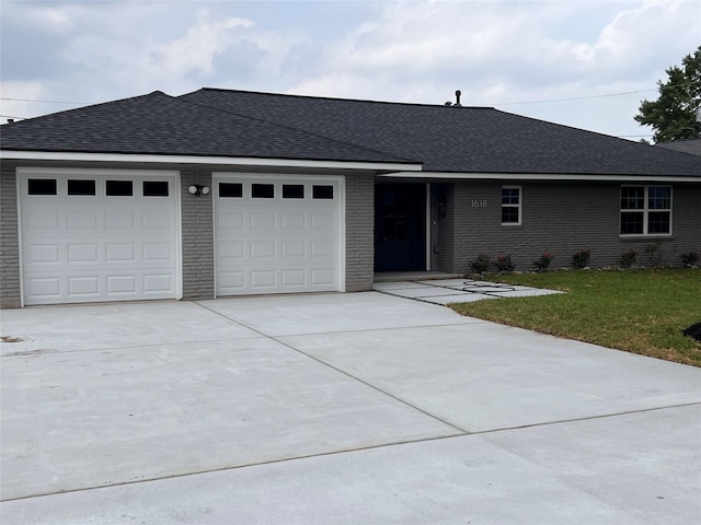 1618 Del Norte St, Houston, TX 77018 - single story home featuring an attached garage, driveway, brick siding, roof with shingles, and a front lawn