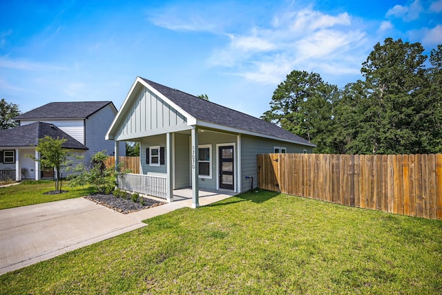 17070 Marie Village Dr, Conroe, TX 77306 - view of front facade featuring board and batten siding, covered porch, and roof with shingles