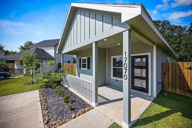 17070 Marie Village Dr, Conroe, TX 77306 - entrance to property with board and batten siding and covered porch
