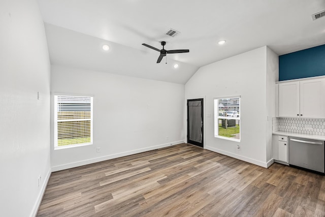 17070 Marie Village Dr, Conroe, TX 77306 - unfurnished living room with vaulted ceiling, plenty of natural light, light wood-style flooring, a ceiling fan, and baseboards
