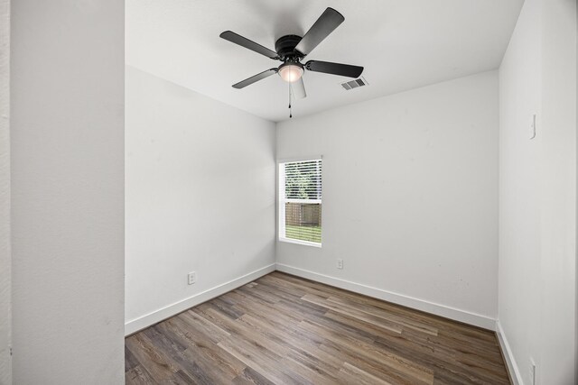 17070 Marie Village Dr, Conroe, TX 77306 - unfurnished room with wood finished floors, baseboards, and a ceiling fan