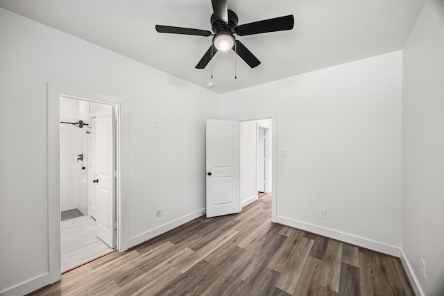 17070 Marie Village Dr, Conroe, TX 77306 - unfurnished bedroom with wood finished floors, baseboards, ensuite bath, and a ceiling fan