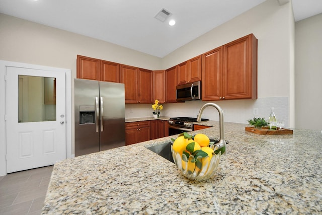 2003 Marthoman Dr, Missouri City, TX 77489 - kitchen with stainless steel appliances, light stone countertops, a sink, recessed lighting, and light tile patterned flooring