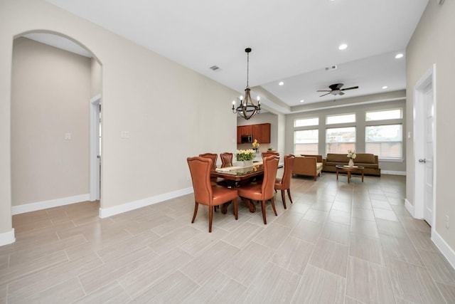 2003 Marthoman Dr, Missouri City, TX 77489 - dining space with a chandelier, a ceiling fan, arched walkways, recessed lighting, and baseboards